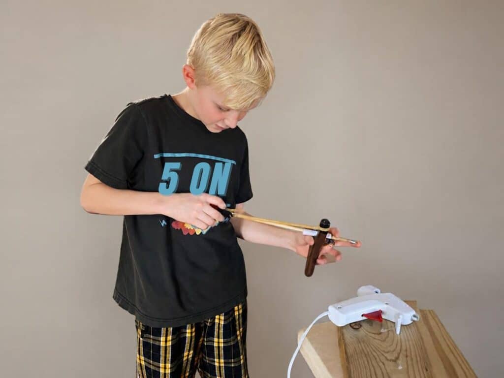 dyslexia has nothing to do with dyslexia. kids are often above average when they have dyslexia, and very creative. they can make anything. as our son here is making something out of hot glue and wood.